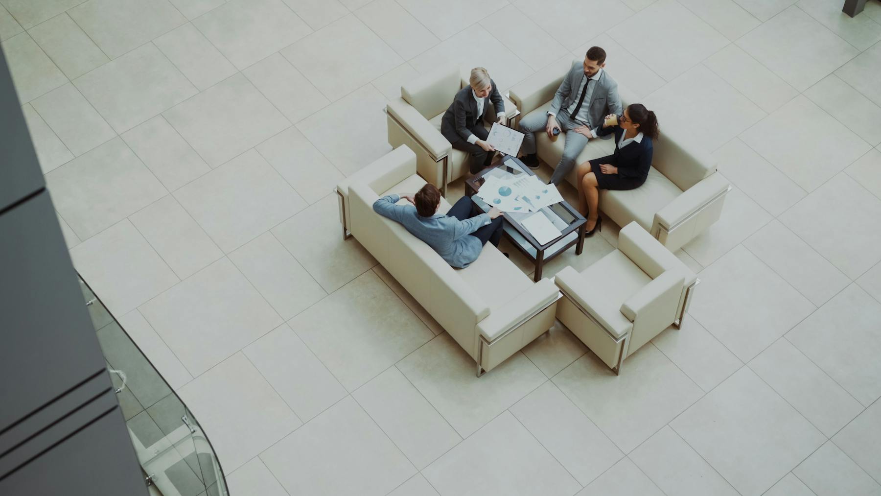 Business team reviewing reports in a modern office lounge